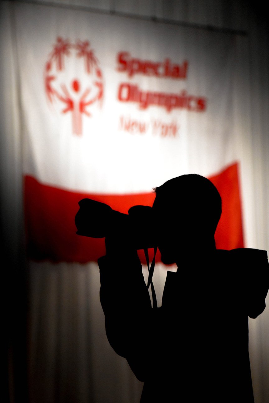 Coburn Swem, a fourth year photojournalism major, frames a shot before the start of the opening ceremony at the Riverside Convention Center in Rochester, N.Y. on Feb. 22, 2019.  Photo by Tony Wen