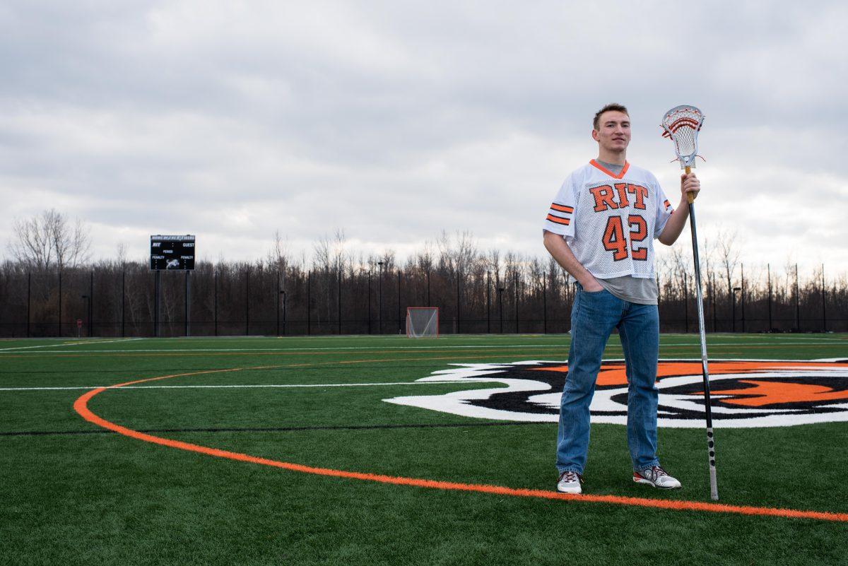 Matt Hossack stands for a portrait on RIT's south turf field adjacent to the Gene Polisseni Center on Feb. 06, 2016. Matt plays defense for the RIT Men's Lacrosse team.  Photograph by Kristen McNicholas.