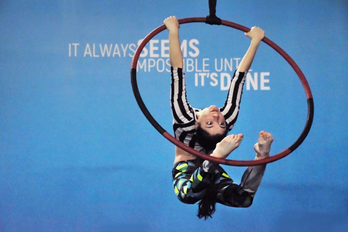 A student at Aerial Arts of Rochester attempts a "Push Bar Out" on the Hoop during the practice session on Saturday, March 30th, 2019, in Rochester, N.Y. Photo by Tony Wen