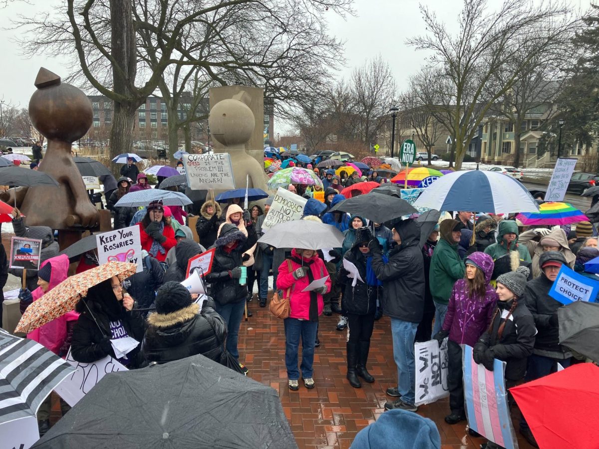 People gather outside the Memorial Art Gallery before the march begins.