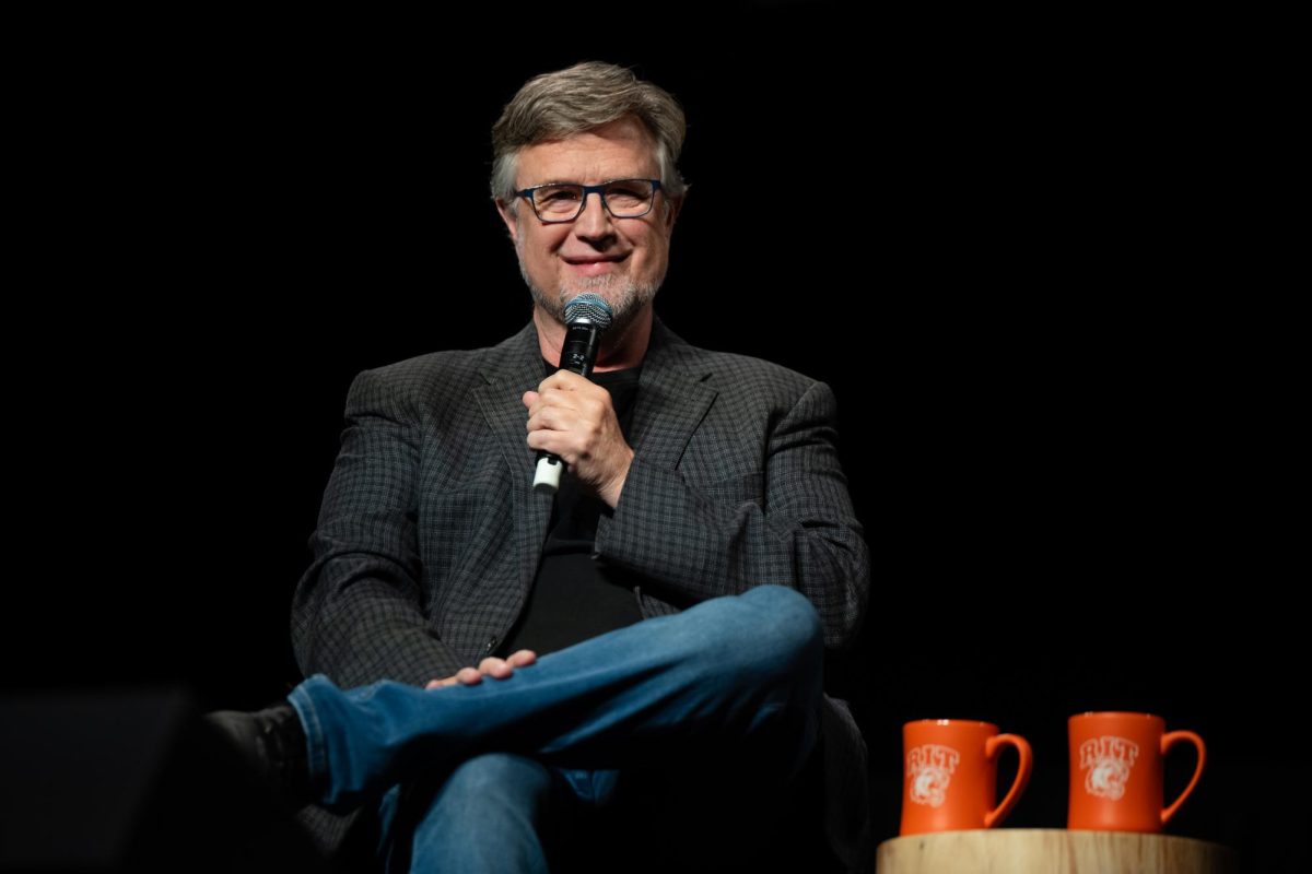 Dan Povenmire smiles toward the crowd during his moderated conversation as part of RIT's Brick City Homecoming in Henrietta N.Y., on Oct. 18, 2025.