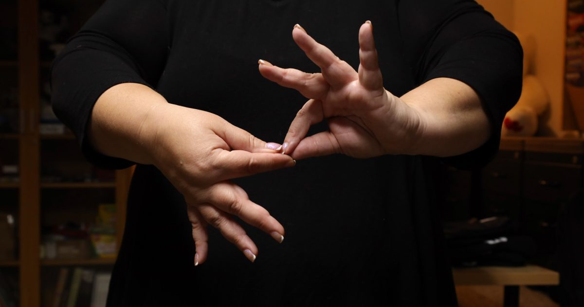 Nancy Kikendall, Associate Interpreter at the National Technical Institute for the Deaf, poses for a photo of her hands forming the word "interpret" in American Sign Language on Oct. 21, 2025.