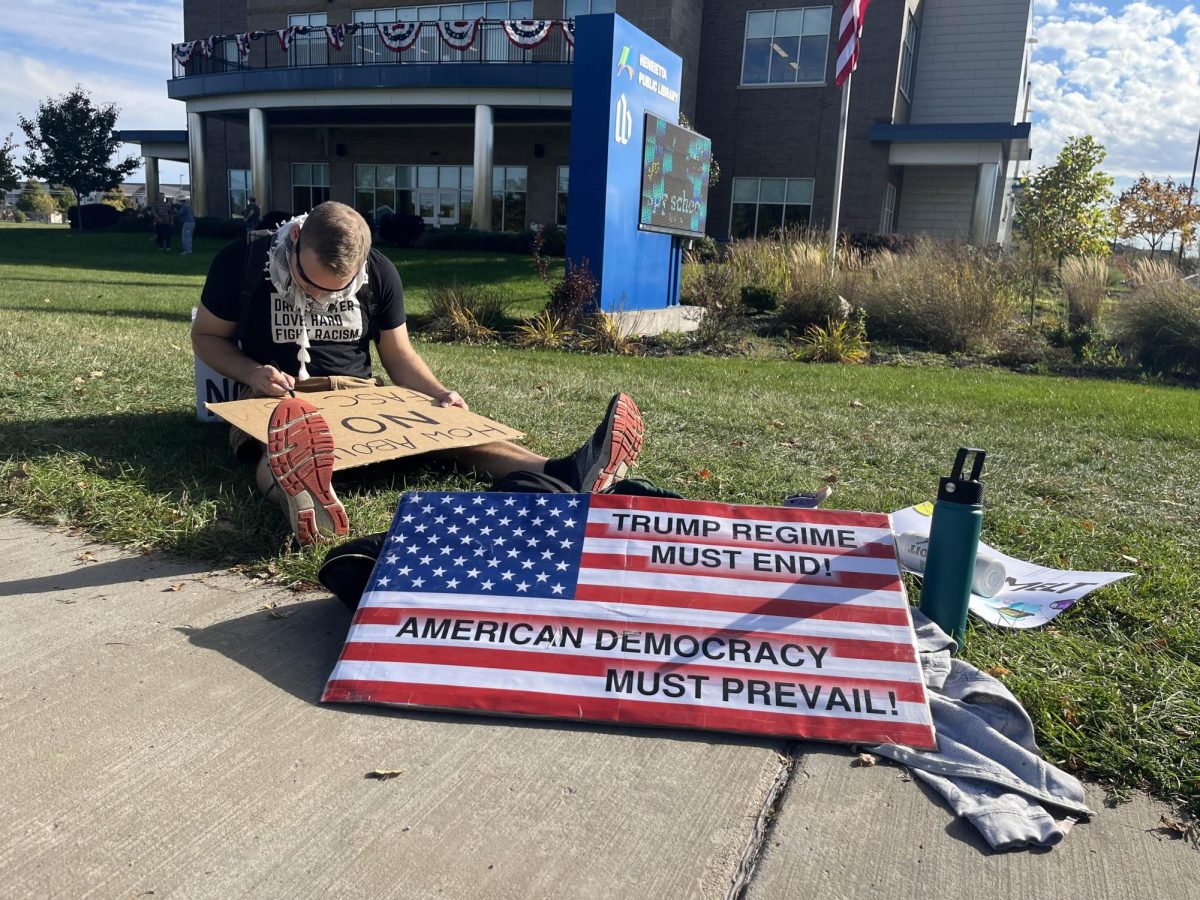 One of over 2,700 ‘No Kings' rallies across the United States occurred in Henrietta, N.Y., where protesters demonstrated peacefully with handmade signs on the sidewalks of Calkins Road.