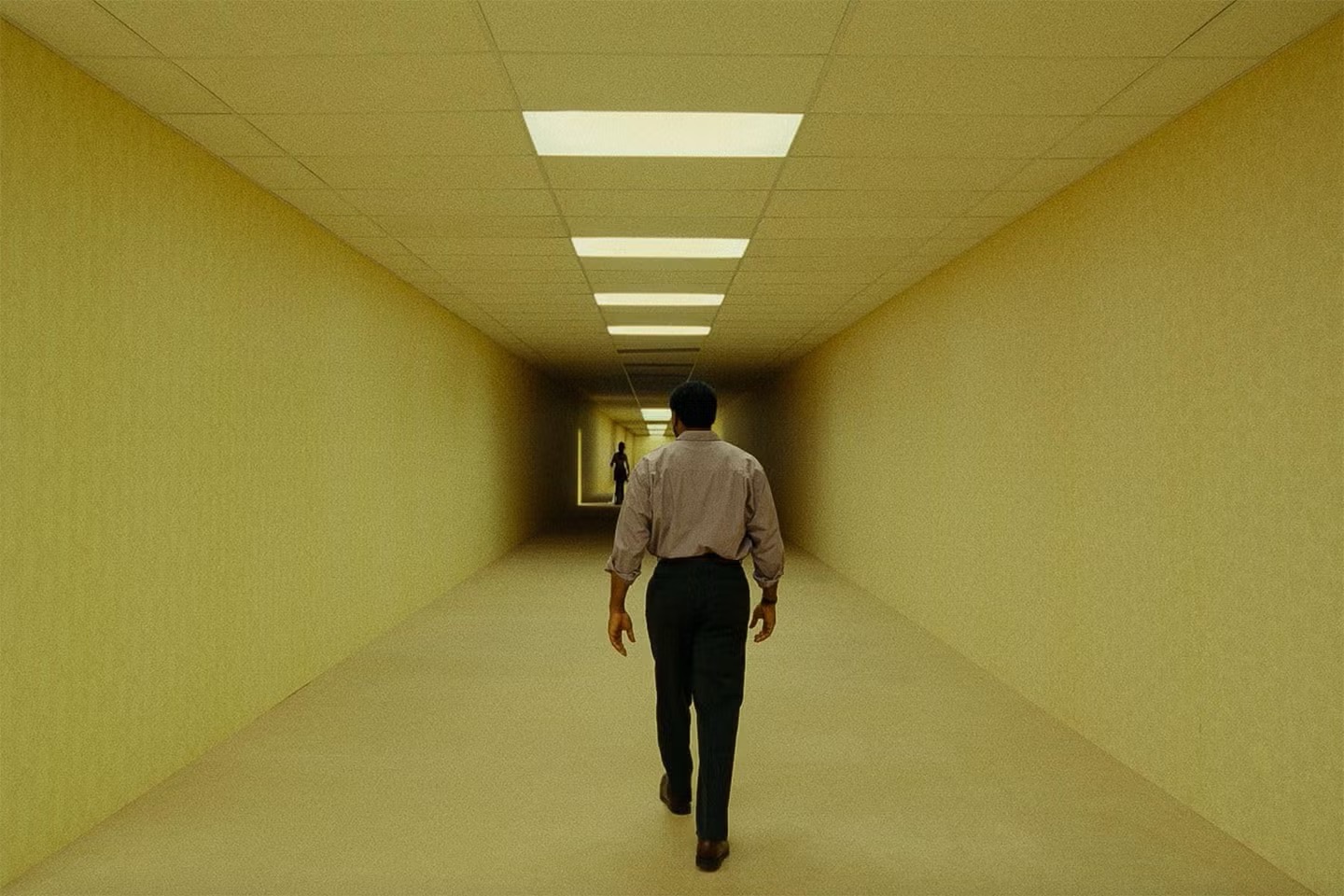 The protagonist, Clark, wanders the hallways of the Backrooms. Photo taken from the Backrooms movie trailer.