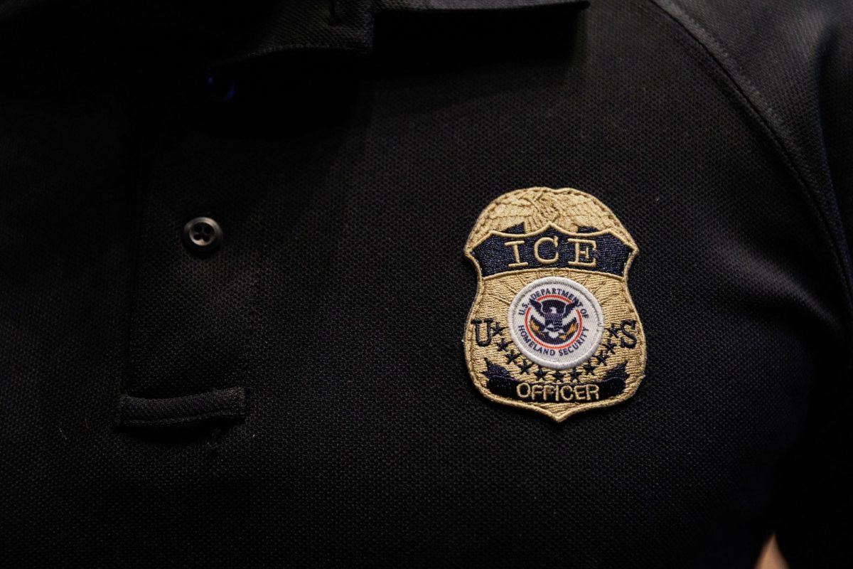 The badge of a U.S. Immigration and Customs Enforcement (ICE) is embroidered on a polo shirt of an ICE employee, at a U.S. Immigration and Customs Enforcement  two-day job fair in Texas to help fill vacancies for deportation officers and attorneys, in Arlington, Texas, U.S. August 26, 2025.  REUTERS/Shelby Tauber