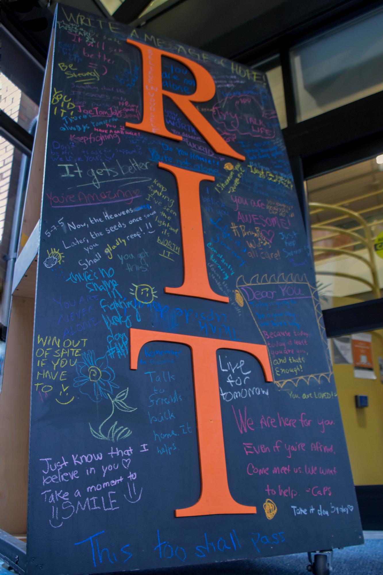 A blackboard outside August Center in Henrietta, N.Y. on Dec. 11, 2018. It is filled with filled with positive quotes written by students at RIT. Photo by Tony Wen