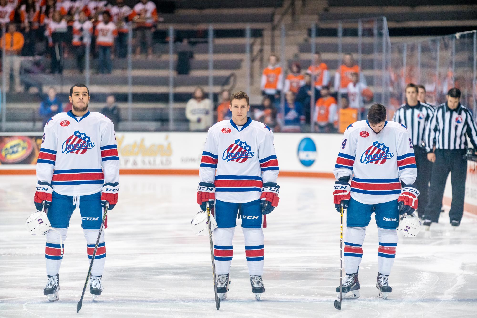 Matt Garbowsky (center) stands on the ice during the National Anthem at the Rochester Americans game at the Gene Polisseni Center on Oct. 11 2015. Photograph by Rob Rauchwerger. 