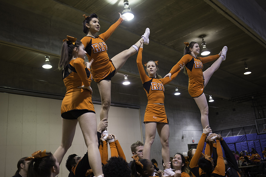 The RIT cheerleading team practices before the basketball game at the Rochester Institute of Technology in Rochester, N.Y. on Feb. 12, 2016. Photograph by Joseph Ressler.