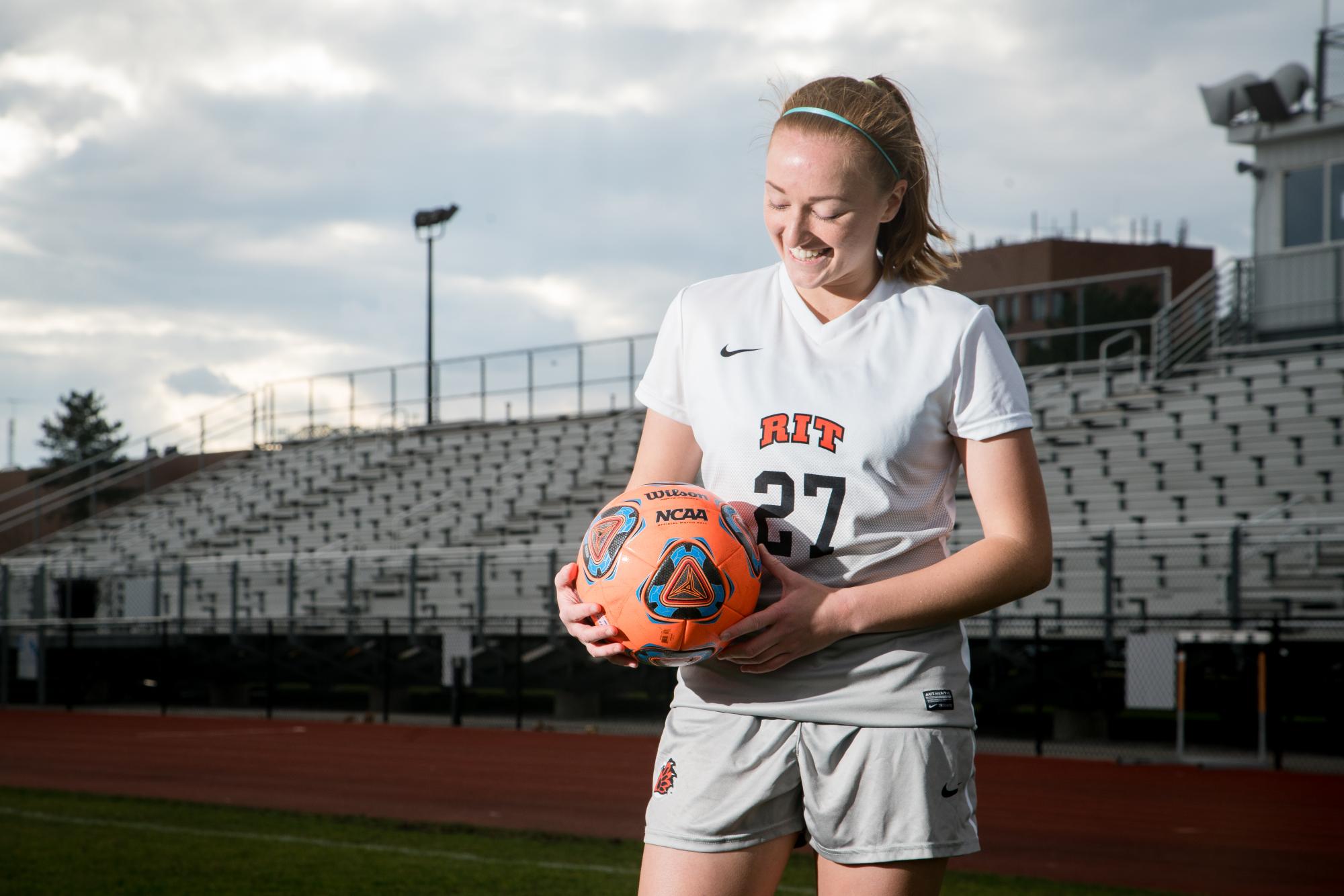 Natalie Hurd poses for portrait on RIT's soccer field. Photograph by Rob Rauchwerger. 